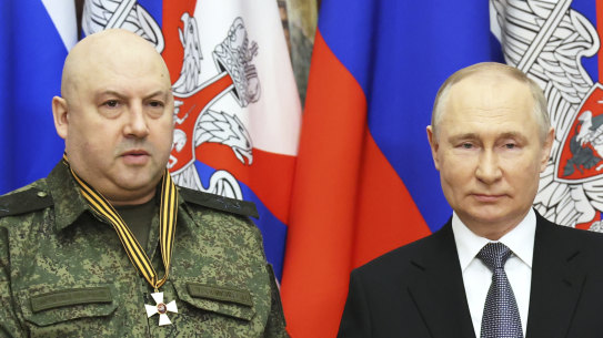 Russian President Vladimir Putin, right, shakes hands with commander of Russia’s military operation in Ukraine General Sergei Surovikin, awarded with order of Saint George of the Third Class, during visit to the headquarters of the Southern Military District, at an unknown location, Russia.