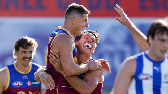 Dayne Zorko of the Lions celebrates a goal with teammates.