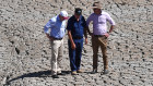 Treasurer Josh Frydenberg, orchard owner Dino Rizzato and Water Resources Minister David Littleproud in a dried-up dam at Cottonvale apple orchard, outside the drought-ravaged town of Stanthorpe, 180km south-west of Brisbane.