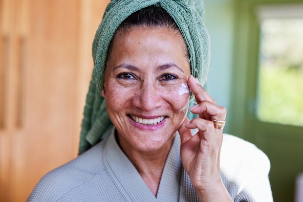 Stock image of a woman applying skincare