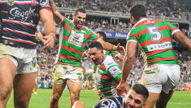 Bragging rights: Greg Inglis celebrates after John Sutton's second-half try against the Roosters.