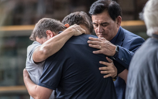 Members of  Muslim community console each other at Hagley College in Christchurch.