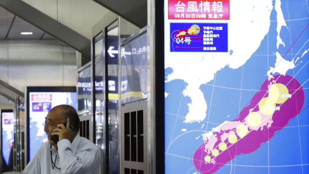 The path of Typhoon Trami is seen on a monitor at Osaka station, in Osaka, western Japan, on Sunday.