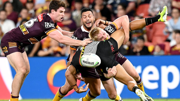 Brisbane’s Tom Dearden tackles Stephen Crichton.