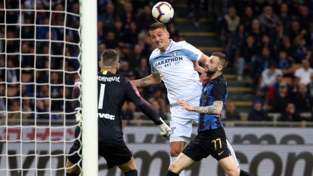 Lazio's Sergej Milinkovic-Savic heads the ball to score past Inter Milan's goalkeeper Samir Handanovic during their match in Milan on Sunday. 