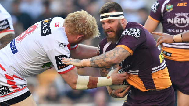 Upsetting the odds: James Graham tackles Josh McGuire of the Broncos in the Dragons' upset at Suncorp Stadium.