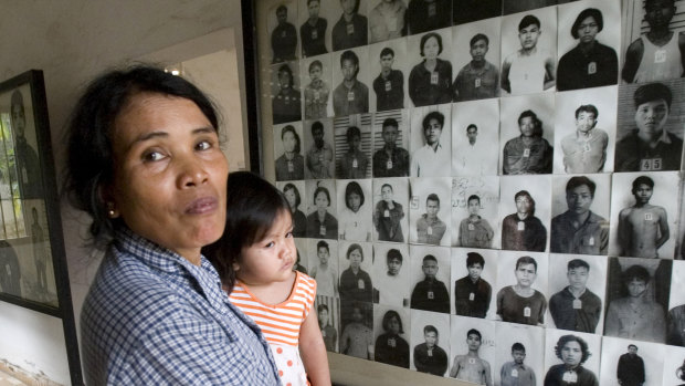 A woman visits a room with portraits of former prisoners at the notorious former Khmer Rouge prison, S-21, now the Tuol Sleng genocide museum in Phnom Penh, Cambodia