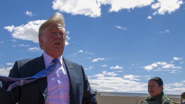 US President Donald Trump visits a section of the border wall in April 2019. 