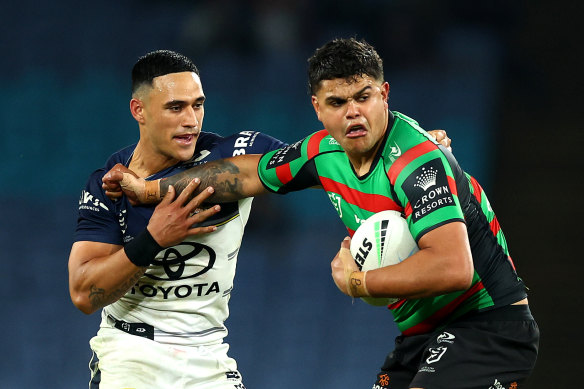 Latrell Mitchell holds off Valentine Holmes.