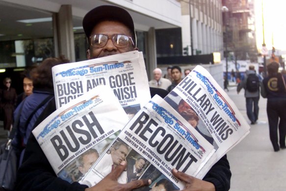 Chicagoan Willie Smith carrying copies of the Chicago Sun-Times with four different headlines. 