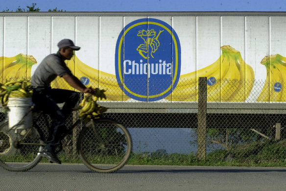 A man cycles past a Chiquita banana truck in La Lima, Honduras.
