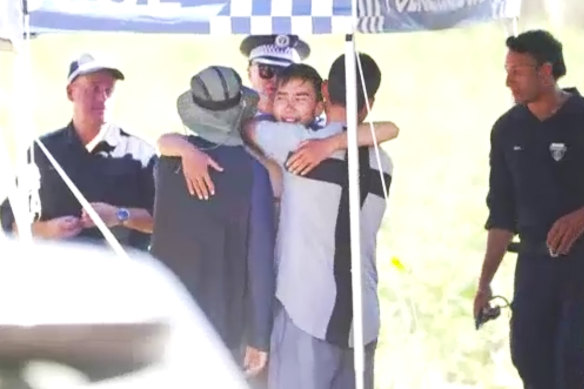 Rescued hiker Hadi Nazari, 23, embraces loved ones on Wednesday.