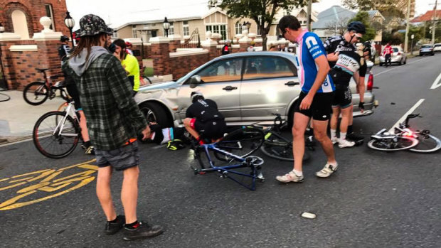Cyclists inspect the damage.