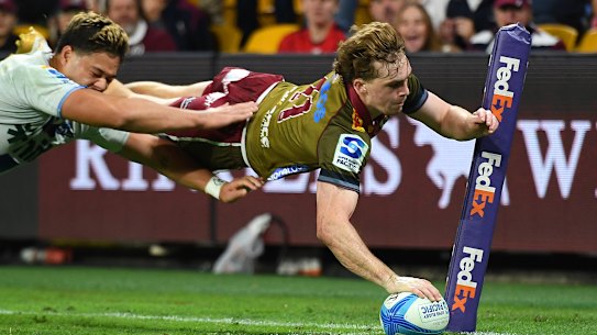 Tim Ryan of the Reds scores one of his three tries.