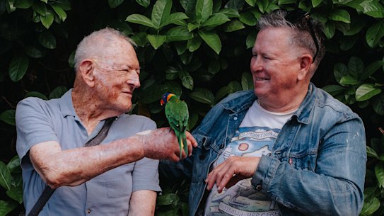 Tom Mehigan, left,  with Jethro Brookes  and lorikeet Rosie.
