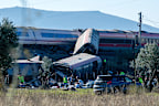 Emergency services attend to the victims at the scene of a collision between two trains in Urda, Spain.