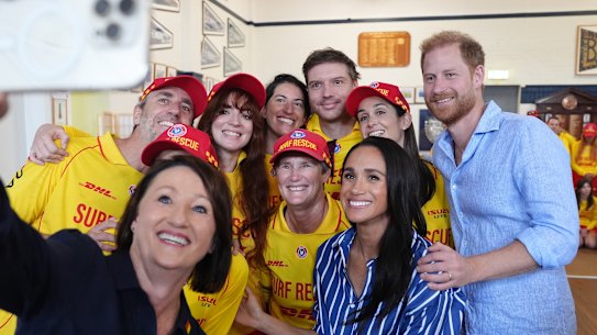 Prince Harry and Meghan pose for a selfie with volunteer first responders at Bondi Surf Bathers’ Life Saving Club.