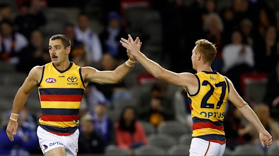 Taylor Walker celebrates a goal with team mate Tom Lynch during the Crows’ clash with North Melbourne.