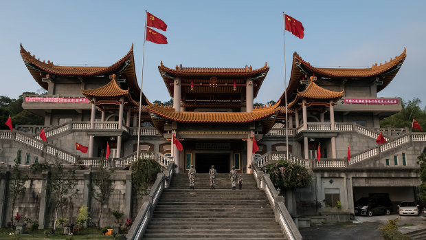 The flags of China and its Communist Party fly above a temple in Ershui Taiwan that was converted into a shrine to communism.