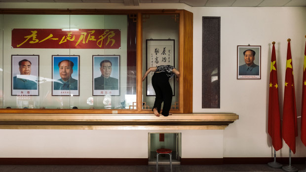 Posters of Chinese communist leader Mao Zedong and other Chinese leaders adorn the former temple.