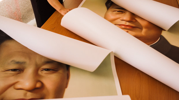 Posters of Chinese communist leader Mao Zedong and Chinese President Xi Jinping at the temple.