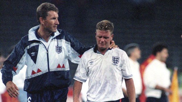 Famous tears: Paul Gascoigne cries as he is escorted off the field by team captain Terry Butcher after losing on penalties to West Germany at the 1990 World Cup.