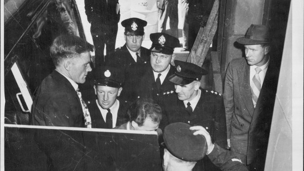 Police Form a guard around John Henry Taylor (left) and William John O'Meally.
