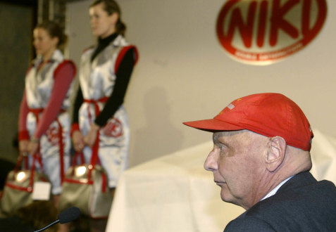 Former Formula One champion Niki Lauda, founder of the new Austrian discount airline Niki is seen during a press conference while stewardesses pose in their uniforms at Vienna's airport, March , 2004. 