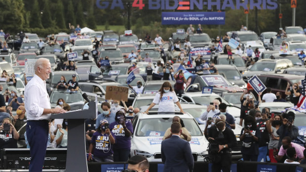 Joe Biden speaks at his drive-in rally at an amphitheatre in Atlanta. 