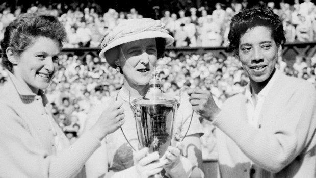  The Duchess of Kent, centre, presents the trophy for the Ladies' Doubles title to Angela Buxton, left, and Althea Gibson, right, following their victory at Wimbledon, England, 1956. 