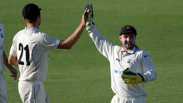 Aaron Hardie is congratulated by Josh Inglis after dismissing the Bulls' Sam Heazlett.