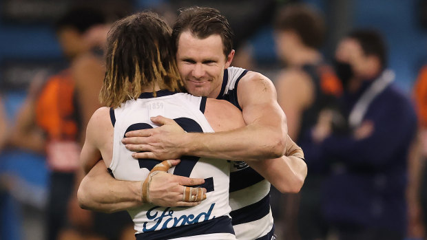 Patrick Dangerfield and Gryan Miers celebrate the Cats’ win over the Giants at Optus Stadium.