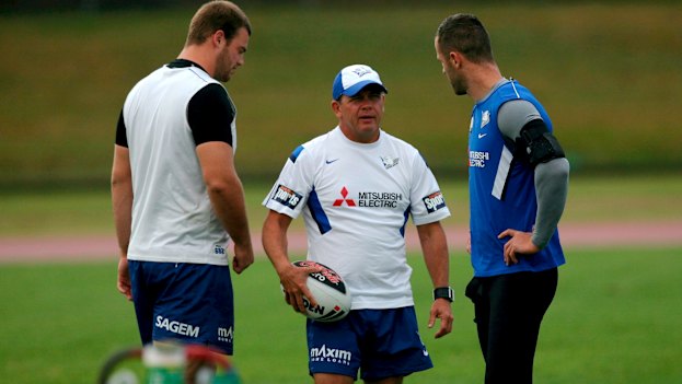 Former Bulldogs coach Kevin Moore (centre) talks to his players at training.