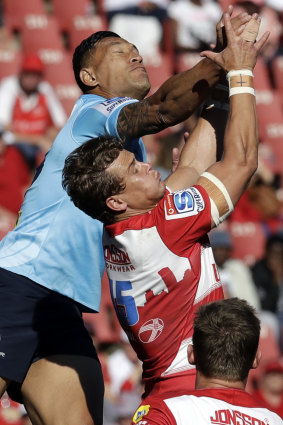 Air control: Israel Folau competes for a high ball against Andries Coetzee. The star fullback has not indicated he is leaving the Waratahs.