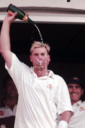 Shane Warne pours champagne over his head in after match celebrations.