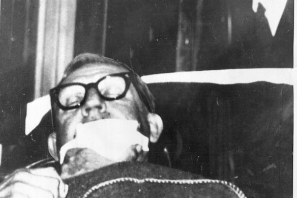 His facial injuries covered by a bandage, Arthur Calwell is wheeled on a stretcher into Sydney’s Royal North Shore Hospital after he was shot on the night of June 21, 1966. 