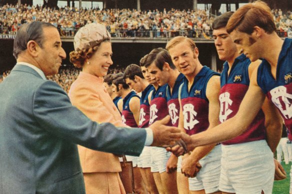The Queen shakes hands with Fitzroy players at the MCG in 1970.