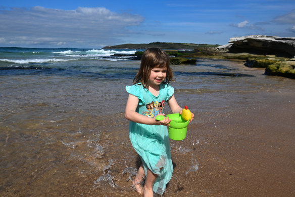 Five-year-old Alice plays in the new cove that has appeared at North Maroubra.