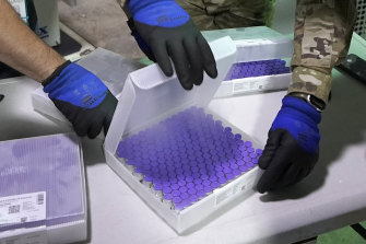 Vials of the Pfizer vaccine are checked at the Madigan Army Medical Centre in Washington state, US.