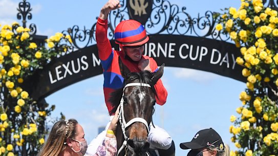 James McDonald raises his hand in triumph on return to the mounting yard at Flemington.