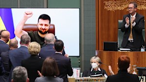 President of Ukraine Volodymyr Zelensky receives a standing ovation after addressing a special sitting via videolink in the House of Representatives.