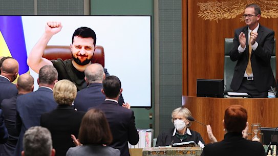 President of Ukraine Volodymyr Zelensky receives a standing ovation after addressing a special sitting via videolink in the House of Representatives.