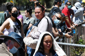 Adelaide residents queue for a coronavirus test at Parafield Gardens in Adelaide on Tuesday.