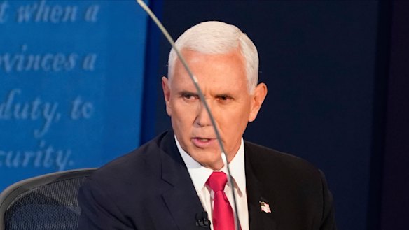 Vice President Mike Pence looks through the plexiglass barrier while he answers a question during the vice-presidential debate.
