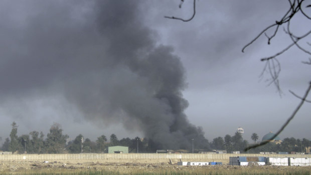 Smoke rises from the US protected Green Zone in central Baghdad, Iraq.