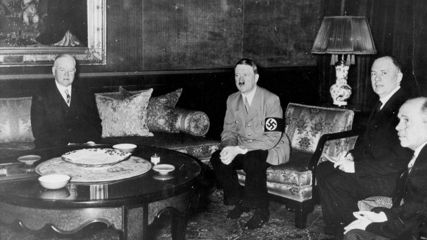 Herbert Hoover, left, meets Adolf Hitler in Berlin in 1938.