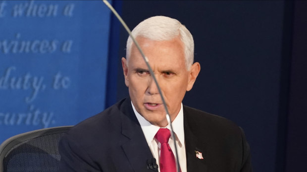 Vice President Mike Pence looks through the plexiglass barrier while he answers a question during the vice-presidential debate.
