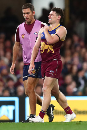 Lachie Neale leaves the field after hurting a shoulder.
