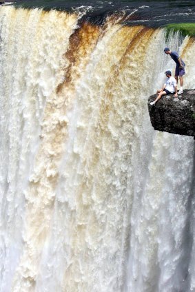 Australia’s 1999 cricket captain Steve Waugh looks with Glenn McGrath from a rocky outcrop at Kaieteur Falls in Guyana.