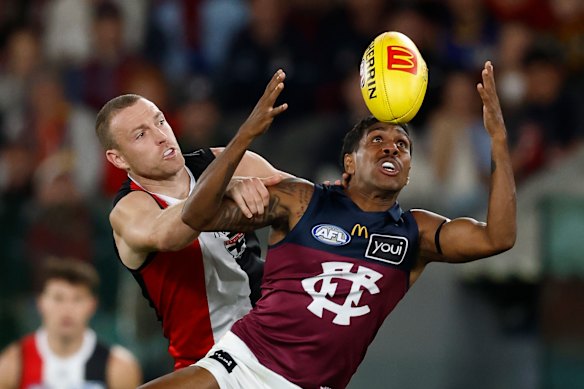 Callum Wilkie of the Saints and Keidean Coleman of the Lions compete for the ball.